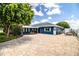 Exterior of home with large driveway, mature landscaping, and ample parking at 1328 Edgewater Beach Dr, Lakeland, FL 33805