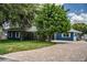 Beautiful blue single-story home with brick driveway and mature trees at 1328 Edgewater Beach Dr, Lakeland, FL 33805