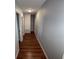 Hallway features wood floors, neutral paint and multiple access doors at 1328 Edgewater Beach Dr, Lakeland, FL 33805