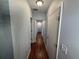 Hallway features wood floors, neutral paint and multiple access doors at 1328 Edgewater Beach Dr, Lakeland, FL 33805