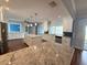 Spacious kitchen with granite countertops, white cabinets, and stainless steel appliances at 1328 Edgewater Beach Dr, Lakeland, FL 33805