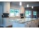 Bright kitchen features granite counters, stainless appliances and a window over the sink at 1328 Edgewater Beach Dr, Lakeland, FL 33805
