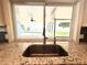 Close up on kitchen sink with views of the backyard pool and patio at 1328 Edgewater Beach Dr, Lakeland, FL 33805