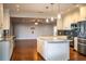 Kitchen featuring stainless steel appliances and granite countertops, open to the living area at 1328 Edgewater Beach Dr, Lakeland, FL 33805