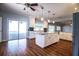 Open kitchen with stainless appliances, island, white cabinets and view of the backyard and pool at 1328 Edgewater Beach Dr, Lakeland, FL 33805