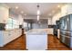 Spacious kitchen featuring stainless appliances, an island and dark backsplash against white cabinetry at 1328 Edgewater Beach Dr, Lakeland, FL 33805