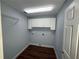 Cozy laundry room featuring cabinets, bright lighting and hookups at 1328 Edgewater Beach Dr, Lakeland, FL 33805