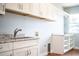 Laundry room featuring granite countertops, ample storage, and built-in shelving at 1328 Edgewater Beach Dr, Lakeland, FL 33805