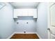 Simple laundry room with built in cabinets, trim and hardwood floors at 1328 Edgewater Beach Dr, Lakeland, FL 33805