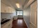 This laundry room offers cabinets, granite countertop, a sink, and window at 1328 Edgewater Beach Dr, Lakeland, FL 33805