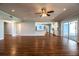 Bright and spacious living room featuring hardwood floors and a ceiling fan, open to the kitchen at 1328 Edgewater Beach Dr, Lakeland, FL 33805