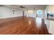 Open living area featuring hardwood flooring and view to remodeled kitchen at 1328 Edgewater Beach Dr, Lakeland, FL 33805