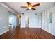 Open living room with wood floors, built-in shelving, and sliding glass doors to the patio at 1328 Edgewater Beach Dr, Lakeland, FL 33805