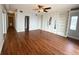 A living room with built-in shelving, wood floors and a doorway to the hall at 1328 Edgewater Beach Dr, Lakeland, FL 33805