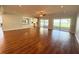 Open-concept living area with hardwood floors and multiple sliding doors to the outside at 1328 Edgewater Beach Dr, Lakeland, FL 33805