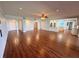 Open living area with hardwood floors and a view into the remodeled kitchen at 1328 Edgewater Beach Dr, Lakeland, FL 33805