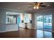 Bright living room showing the open concept to the kitchen and view of the screened pool outside at 1328 Edgewater Beach Dr, Lakeland, FL 33805