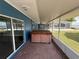 Covered patio with a hot tub, offering an inviting space for relaxation and entertaining while enjoying the lake views at 1328 Edgewater Beach Dr, Lakeland, FL 33805