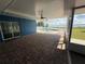 Covered patio featuring an enclosed swimming pool and views of the lake at 1328 Edgewater Beach Dr, Lakeland, FL 33805