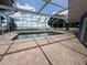 A screened-in pool with brick surround, under a bright, partly-cloudy sky, near the lake at 1328 Edgewater Beach Dr, Lakeland, FL 33805