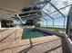 A screened-in pool with brick surround offers clear water and views of the nearby lake at 1328 Edgewater Beach Dr, Lakeland, FL 33805
