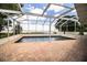 Relaxing screened pool area with brick pavers offers stunning views of the lake at 1328 Edgewater Beach Dr, Lakeland, FL 33805