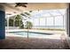 Enjoy the screened pool with a serene lake view, creating a perfect outdoor oasis at 1328 Edgewater Beach Dr, Lakeland, FL 33805