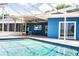 Inviting pool area connects to the blue house, providing easy access and stunning views at 1328 Edgewater Beach Dr, Lakeland, FL 33805