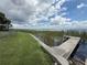 Waterfront property featuring a concrete seawall, pier and lakeside view at 1328 Edgewater Beach Dr, Lakeland, FL 33805