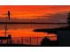 Waterfront at sunset with dock and tranquil lake views at 1328 Edgewater Beach Dr, Lakeland, FL 33805