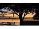 Waterfront at dawn featuring a tranquil lake and dock at 1328 Edgewater Beach Dr, Lakeland, FL 33805