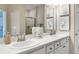 Bathroom featuring double sinks, framed mirrors, and a tiled shower, creating a functional yet stylish space at 1368 Melrose St, Lake Alfred, FL 33850