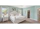 Bright bedroom features a comfortable bed, stylish decor, and natural light, creating a cozy, inviting space at 1368 Melrose St, Lake Alfred, FL 33850