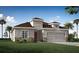 Charming single-Gathering home featuring a two-car garage and beautifully landscaped front yard and neutral exterior at 1368 Melrose St, Lake Alfred, FL 33850