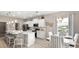Well-lit kitchen featuring modern appliances, white cabinets, granite countertops, and adjacent dining area at 1368 Melrose St, Lake Alfred, FL 33850