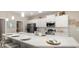 Bright kitchen features stainless appliances, white cabinets, an island, and pendant lighting for a modern touch at 1368 Melrose St, Lake Alfred, FL 33850