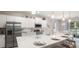 Bright, modern kitchen featuring stainless steel appliances, a large island with seating, and pendant lighting at 1368 Melrose St, Lake Alfred, FL 33850