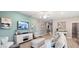 Bright living room with stylish furniture, decor and modern entertainment center offers comfortable, airy atmosphere at 1368 Melrose St, Lake Alfred, FL 33850