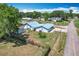 Aerial view of home with large yard, mature trees and metal roof at 1405 Clinton St, Bartow, FL 33830