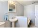 Bathroom with a pedestal sink, vanity mirror, and combination tub and shower at 1405 Clinton St, Bartow, FL 33830