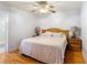 Comfortable bedroom featuring a bed, ceiling fan, and wood flooring at 1405 Clinton St, Bartow, FL 33830