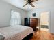 Comfortable bedroom with hardwood flooring, ceiling fan, and neutral decor at 1405 Clinton St, Bartow, FL 33830