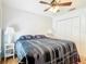 Bedroom with wood floor, ceiling fan, closet, and two side tables at 1405 Clinton St, Bartow, FL 33830