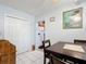 Bright dining room with tile flooring, a view into the kitchen, and closet storage at 1405 Clinton St, Bartow, FL 33830