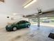 Well-lit garage with ample space for parking and storage, featuring a car inside at 1405 Clinton St, Bartow, FL 33830