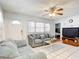 Cozy living room featuring comfortable seating, tile flooring and a ceiling fan at 1405 Clinton St, Bartow, FL 33830