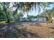 Expansive backyard featuring mature trees and greenery, offering ample space for outdoor activities at 1507 Holly Rd, Lakeland, FL 33801