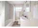 Clean bathroom with a tub-shower combo, modern vanity, and bright, neutral finishes at 1507 Holly Rd, Lakeland, FL 33801