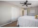 Bedroom featuring a queen-size bed, closet, ceiling fan, and light-colored walls with carpet flooring at 1507 Holly Rd, Lakeland, FL 33801