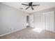 Neutral bedroom featuring a ceiling fan, carpet flooring, and a closet at 1507 Holly Rd, Lakeland, FL 33801